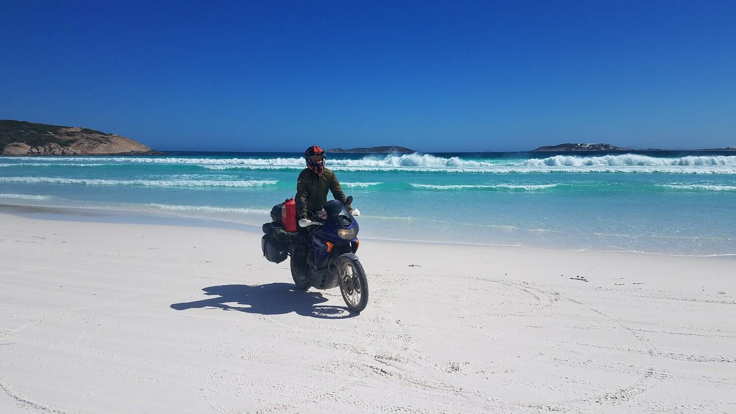 motorcycle riding on white sand beach