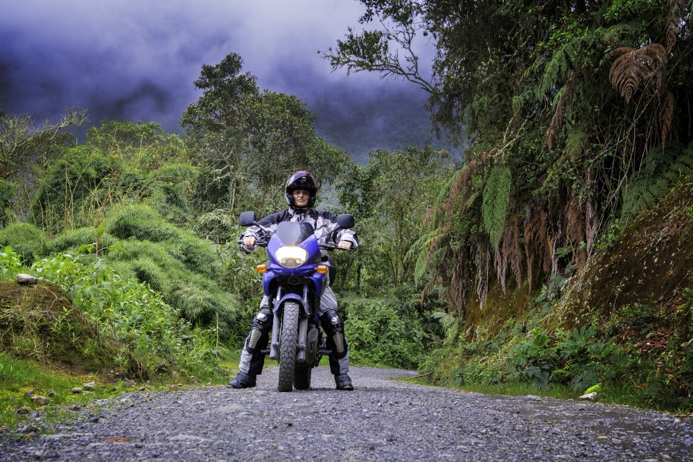 rider on a motorcycle on a jungle covereed mountain