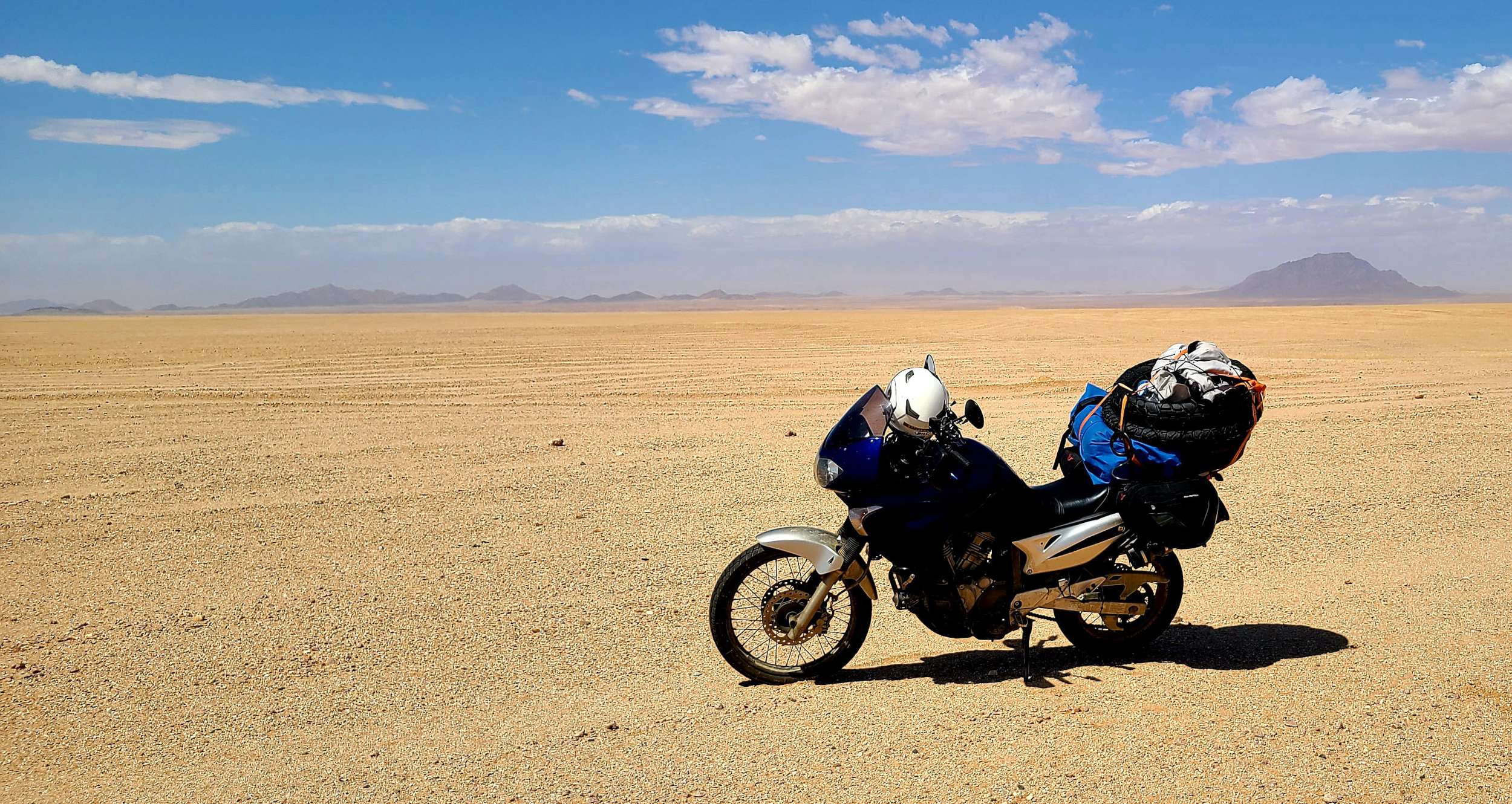 a heavily loaded motorcycle in desert 