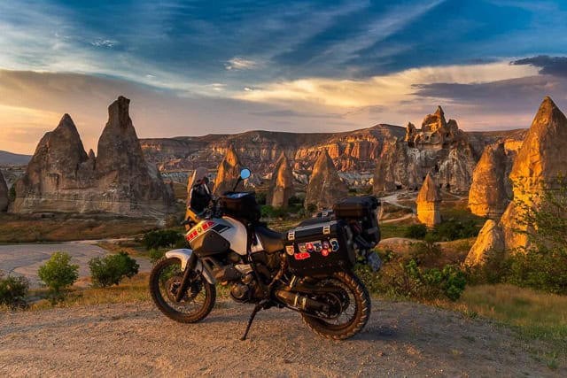 motorcycle parked with strange rock outcrops behind