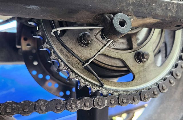 view of a procket and hose lightly touching it at 7 o'clock position