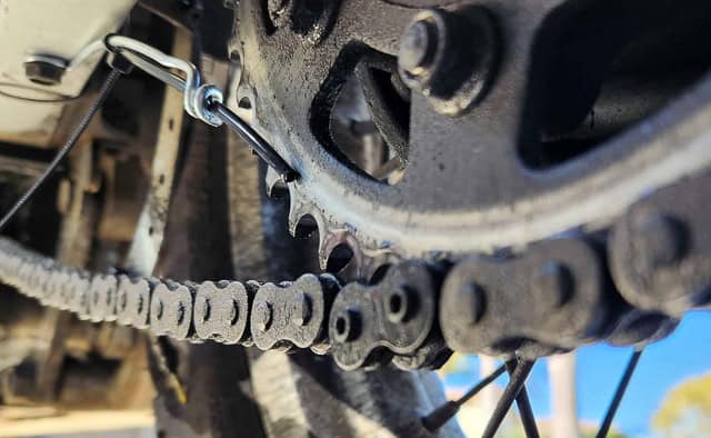 view of wire holding hose against sprocket